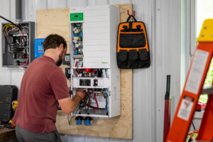 installer connecting rubix battery to electrical panel