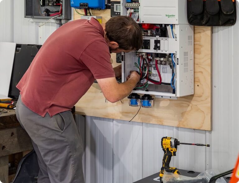 man working on panel for rubix battery
